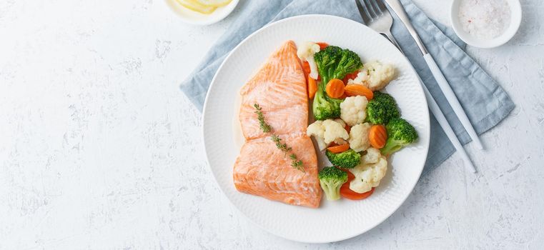 Steam salmon and vegetables, Paleo, keto, fodmap, dash diet. Mediterranean diet with steamed fish. Healthy concept, white plate on gray table, gluten free, lectine free, top view, long banner