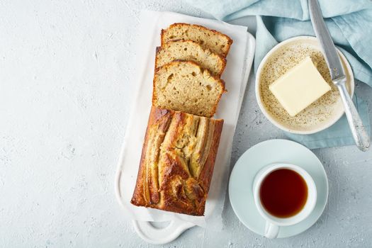 Banana bread. Cake with banana, traditional american cuisine. Slice of loaf. Gray background, copy space. Top view