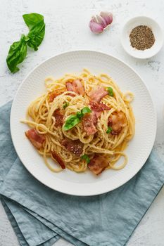 Carbonara pasta. Spaghetti with pancetta, egg, parmesan cheese and cream sauce. Traditional italian cuisine. Top view, vertical