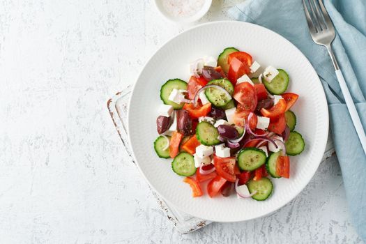Greek village salad horiatiki with feta cheese, olives, cherry tomato, cucumber and red onion, vegeterian mediterranean food, low calories dieting meal, copy space