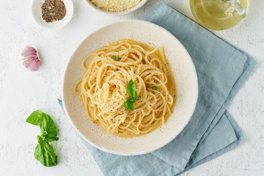 Cacio e pepe pasta. Spaghetti with parmesan cheese and pepper. Traditional italian cuisine. Top view,