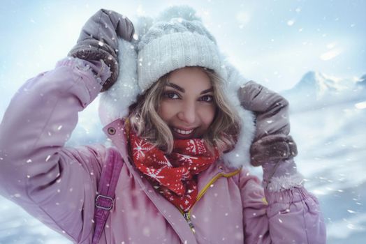 The charming woman walks among the winter mountains at ski resort. The ice in the frozen lake shifting and make amazing noises. The acoustics of the frozen lake creates a dreamy atmosphere.
