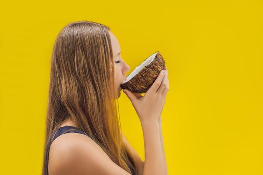 Young woman doing oil pulling over yellow background.