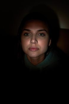 Facial portrait of a young beautiful girl with long dark hair. Low key woman portrait