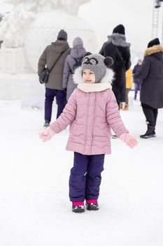 kid happy at ice sculpture festival on winter day