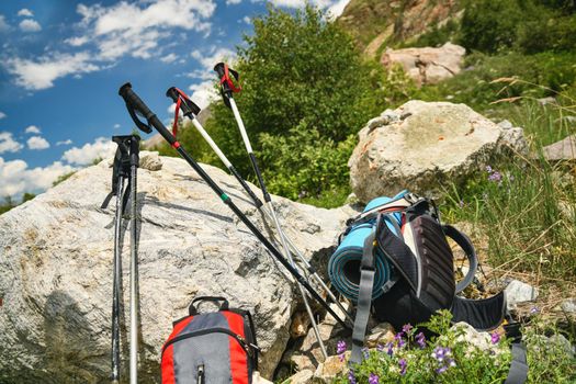 Nordic walking sticks, backpack in the mountains