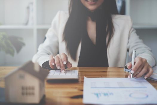 Asian Business woman or broker checking contract agreement paper with customer to sign contract. Real Estate and Agreement concept