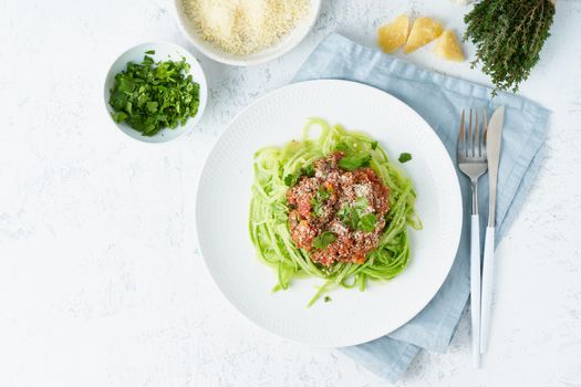Keto pasta Bolognese with mincemeat and zucchini noodles, fodmap, lchf, low carb, ketogenic diet. Top view, copy space. Clean eating, balanced food.