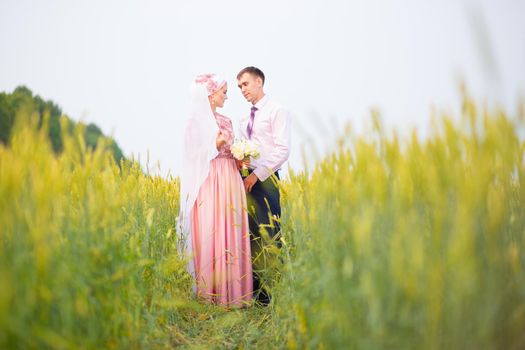 National wedding. Bride and groom in the field. Wedding muslim couple during the marriage ceremony. Muslim marriage.