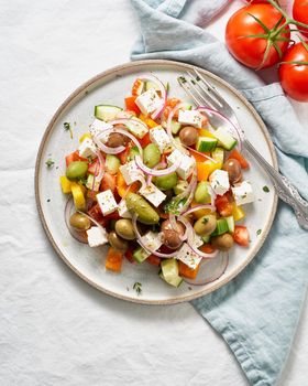 Greek village salad horiatiki with feta cheese and vegetables, vegeterian mediterranean food, low calories dieting meal, vertical, copy space