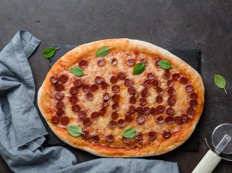 Father's day background. Pepperoni pizza with i love dad lettering on black background. Father day concept, recipe and idea. Top view or flat-lay. Copy space for text.