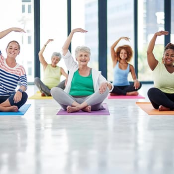 Shot of a group of women doing yoga indoors