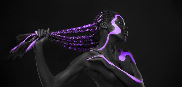 Neon concept. Pink and black body paint. Woman with face art. Young girl with bodypaint. An amazing model with makeup.