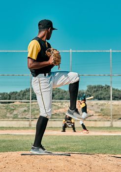 Shot of a young baseball player getting ready to pitch the ball during a game outdoors