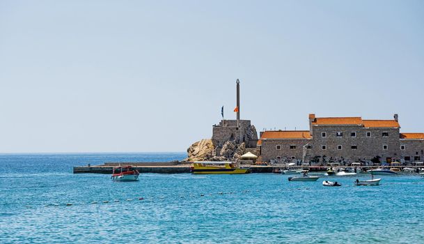 Yachts port in Montenegro in Adriatic sea. Boats pier in sunny day in Mediterranean sea