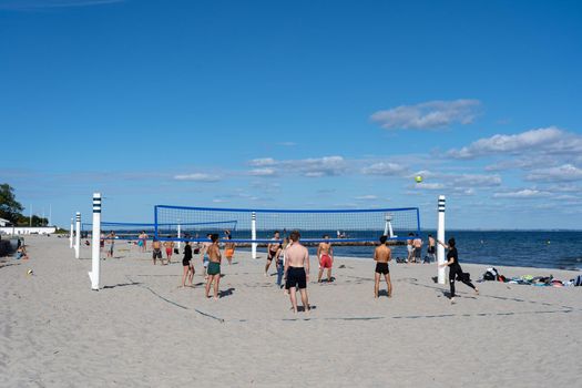 Klampenborg, Denmark - September 04, 2021: People playing beach volleyball at Bellevue Beach.