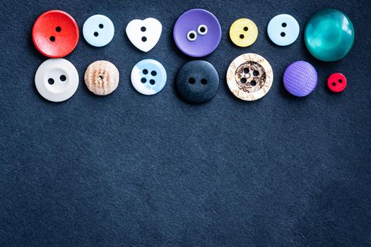 Top view on assortment of sewing buttons with copy space