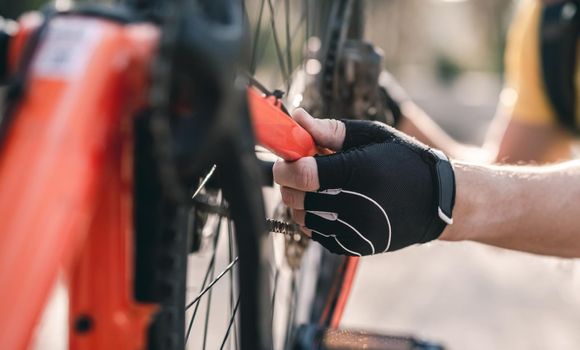 Cyclist checking mechanism on upside down bicycle outdoors