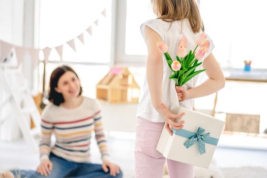 Tulips and gift box from daughter for happy mother