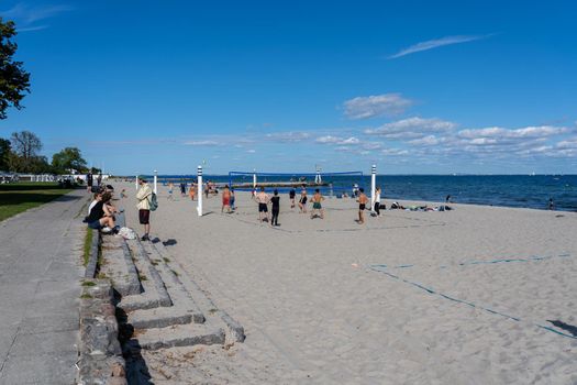 Klampenborg, Denmark - September 04, 2021: People playing beach volleyball at Bellevue Beach.