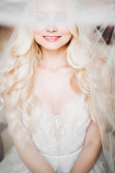 Monochrome portrait of sensuality and charming smiling young blondie. Beautiful sexy lady with long hair, and perfect make up dreaming with closed eyes. Concept of beauty. Morning of bride.