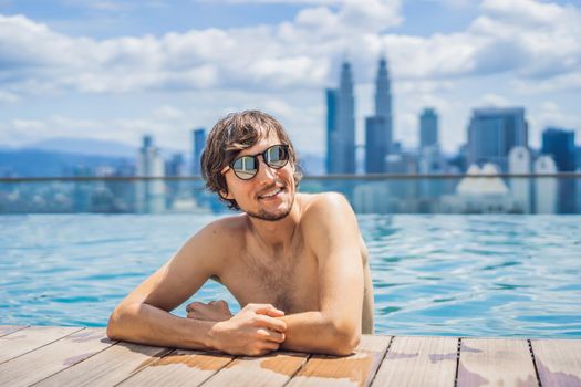 Man relax in swimming pool in sunrise, on rooftop in the city. Rich people.