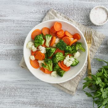 Mix of boiled vegetables. Broccoli, carrots, cauliflower. Steamed vegetables for dietary low-calorie diet. FODMAP, dash diet, vegan, vegetarian, top view