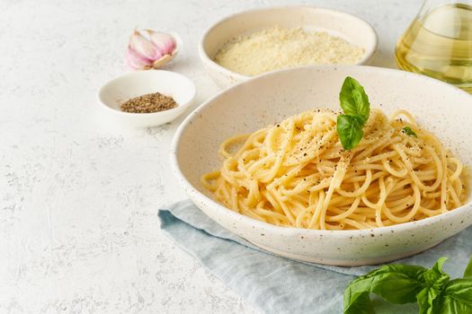 Cacio e pepe pasta. Spaghetti with parmesan cheese and pepper. Traditional italian cuisine. Top view, side view