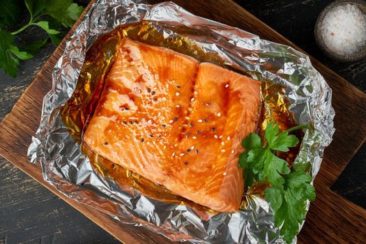 Foil pack dinner with fish. Fillet of salmon. Healthy diet food, keto diet, Mediterranean cuisine. Oven-baked hot dinner. Top view, macro