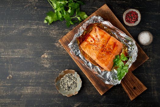 Foil pack dinner with fish. Fillet of salmon. Copy space. Healthy diet food, keto diet, Mediterranean cuisine. Oven-baked hot dinner. Top view, close up