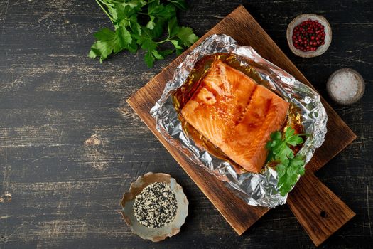 Foil pack dinner with fish. Fillet of salmon. Copy space. Healthy diet food, keto diet, Mediterranean cuisine. Oven-baked hot dinner. Top view, close up