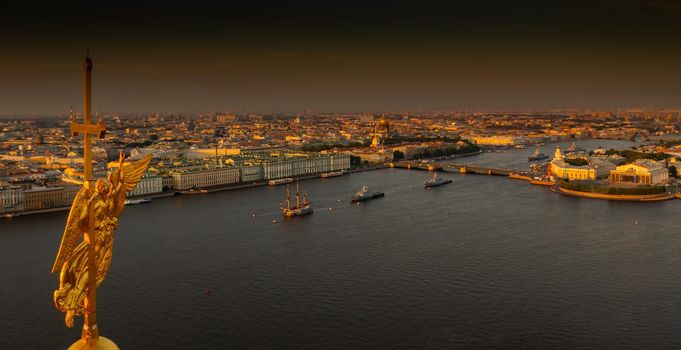 The golden angel on the cross of the Peter and Paul Fortress at sunrise, landmarks of St. Petersburg on background, Isaac cathedral, Admiralty, Rostral columns, Winter Palace. High quality photo