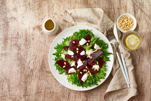 salad with beet, curd, feta, ricotta and pine nuts, lettuce. Healthy keto ketogenic dash diet, top view, copy space