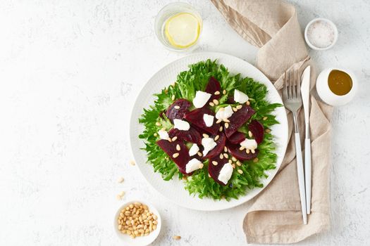 salad with beet, curd, feta, ricotta and pine nuts, lettuce. Healthy keto ketogenic dash diet, top view, copy space