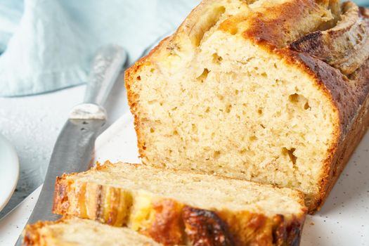 Banana bread. Cake with banana, traditional american cuisine. Slice of loaf. Gray background. Side view, close up