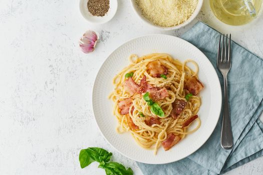 Carbonara pasta. Spaghetti with pancetta, egg, parmesan cheese and cream sauce. Traditional italian cuisine. Top view, copy space