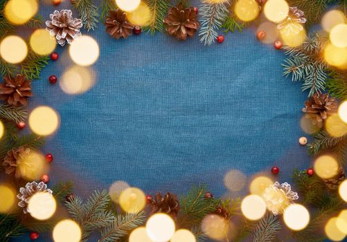 Christmas and Happy New Year dark blue background cope space for text and bokeh of light garland. Frame for recipe, menu with craft paper. Textile backdrop with copy space.