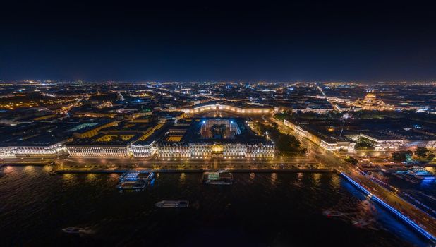 The picturesque night landscape of Winter Palace and Palace square with night illumination, night illumination of buildings and streets, many boats. High quality photo