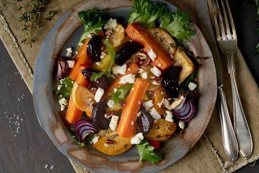 Vegetarian salad sheep cheese, baked roasted vegetables, keto ketogenic dash diet. Mix of carrots, beets, turnips, rutabaga, onions and a nuts. Clean eating. Top view