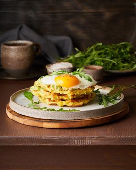 Chaffles, ketogenic diet health food. Homemade keto waffles with fried egg, mozzarella cheese. Gluten free and carb free. Dark background, vertical