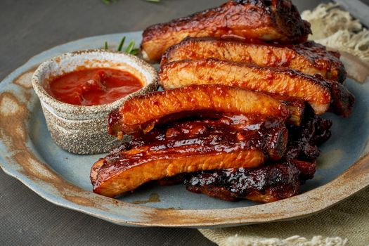 Keto food, spicy barbecue pork ribs. Slow cooking recipe. Pickled Roasted Pork Meat with red sauce. Asian Cuisine, Korean. Side view, close up