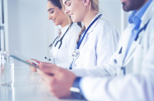 Doctors at the meeting, sitting on the desk.