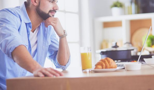 Man preparing delicious and healthy food in the home kitchen.