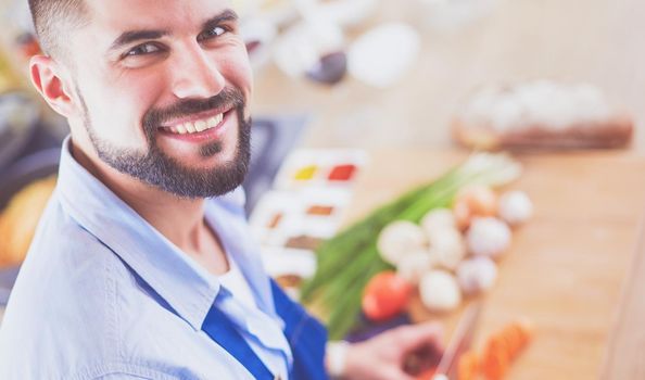 Man preparing delicious and healthy food in the home kitchen.