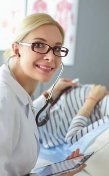 Doctor and patient discussing something while sitting at the table . Medicine and health care concept.