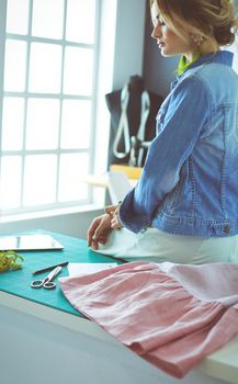 Fashion designer woman working on her designs in the studio.