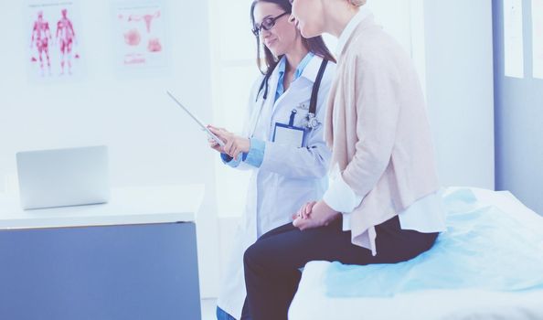 Doctor and patient discussing something while sitting at the table . Medicine and health care concept.