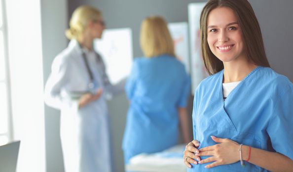 Beautiful smiling pregnant woman with the doctor at hospital.