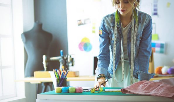 Fashion designer woman working on her designs in the studio.