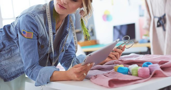 Fashion designer woman working on her designs in the studio.